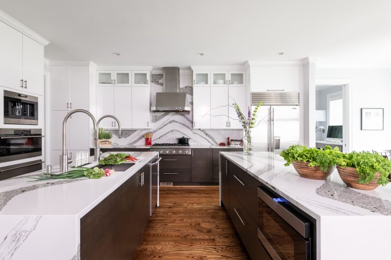 open plan kitchen with double kitchen island, double sink, with white custom cabinetry matching backsplash and stainless-steel kitchen sink faucet with pull out sprayer, fingerprint resistant