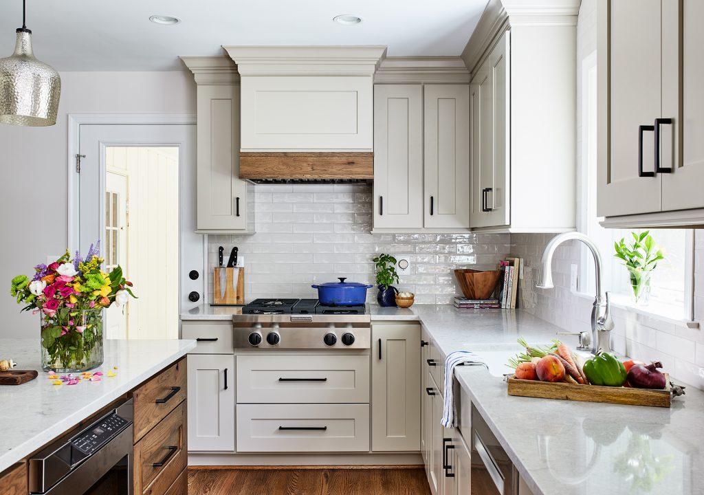 transitional kitchen with subway grey tiles backsplash freestanding cabinets, vent hood over the gas cooktop with 4 burners in stainless steel