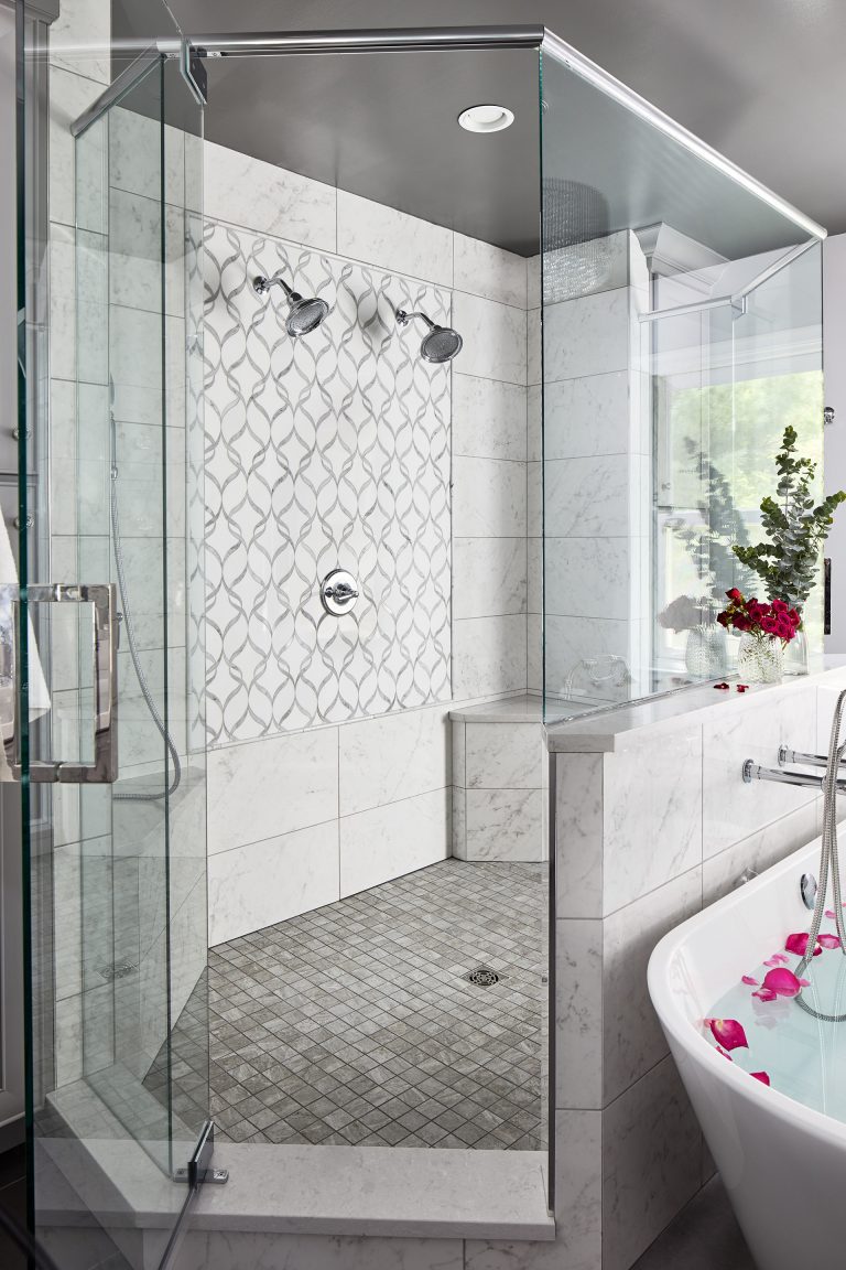 bathroom with large walk in shower with two shower heads