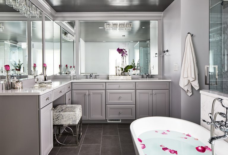 transitional bathroom with large frame mirror with light fixtures bathroom vanity sits right between the tub and the shower enclosure.