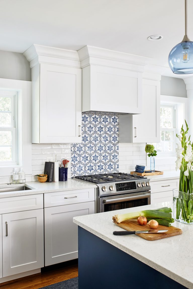 case kitchen design with blue and white backsplash, white cabinets with pull handles