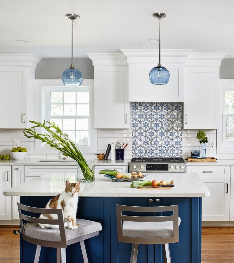 two tall kitchen island chairs with blue shade pendant white and blue backsplash wood floors