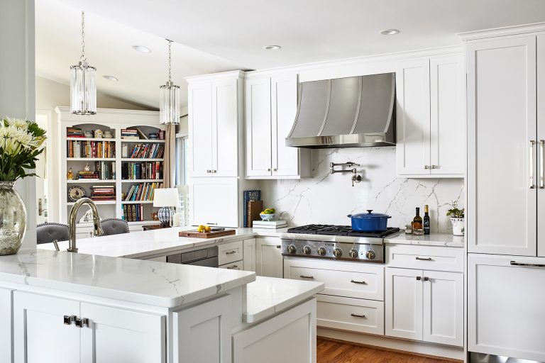 case remodeling kitchen with tall white cabinets with pull handles and hidden refrigerator, hood over your range