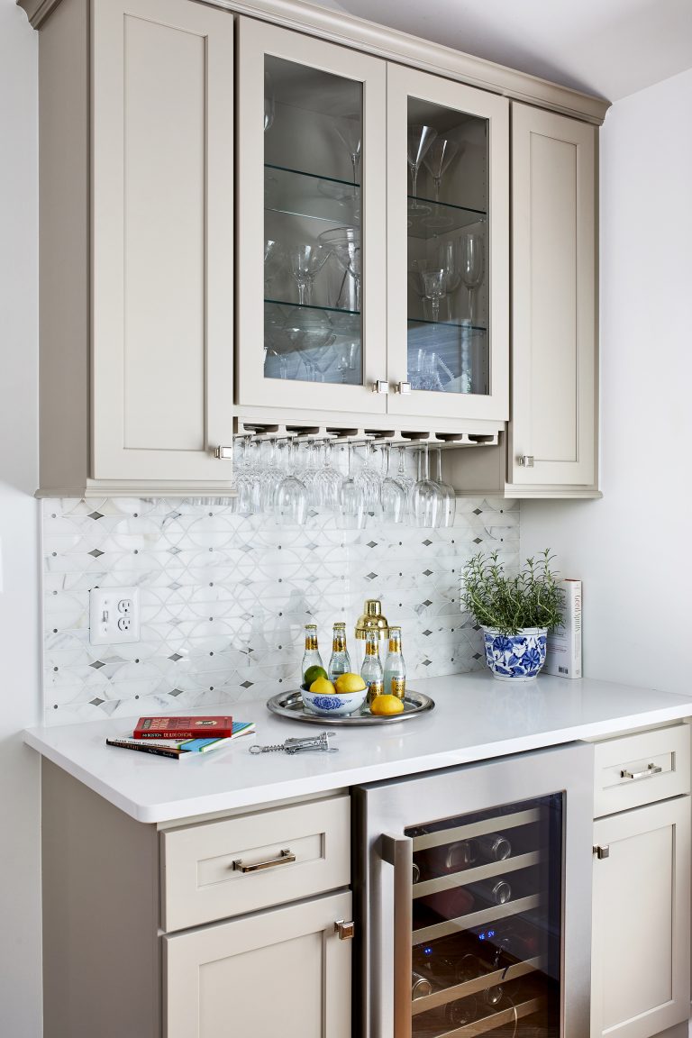 remodeling in Virginia with a white kitchen cabinet with wine refrigerator, as well as glass storage