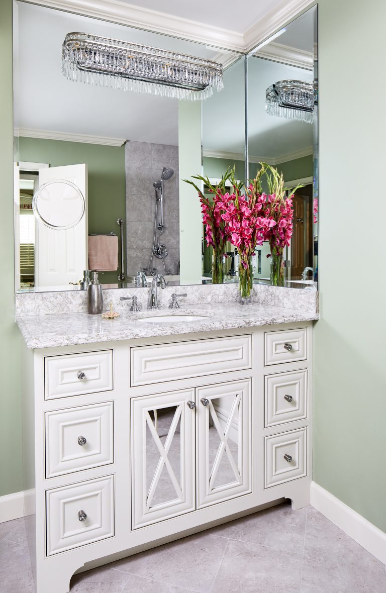 white single sink vanity, marble countertop with two glass doors and huge mirror