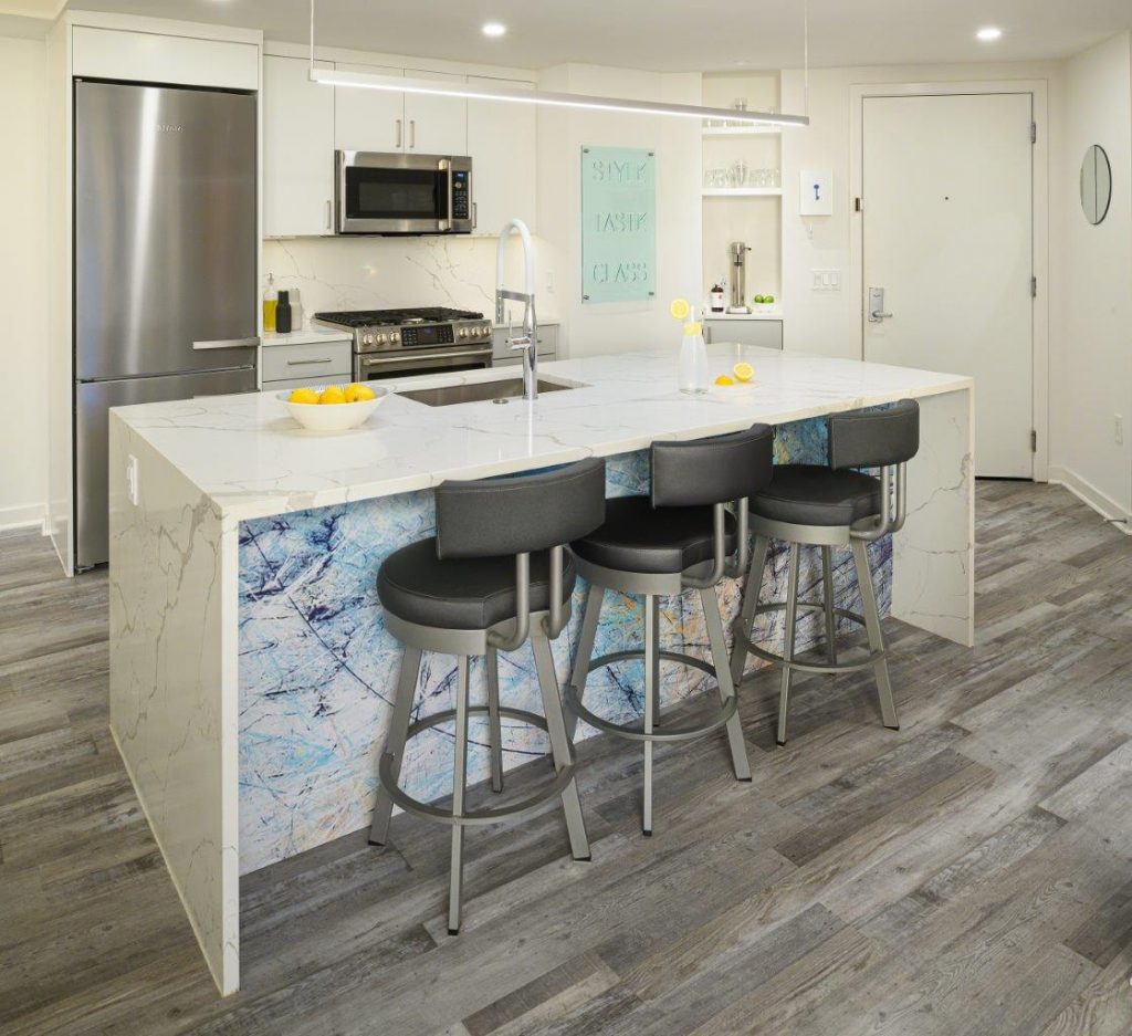 case design kitchen in DC has LED Linear Pendant packs a lot of lumens into an ultra-thin linear-suspension frame, minimal lines, maximum light and a marble kitchen island with three seatings