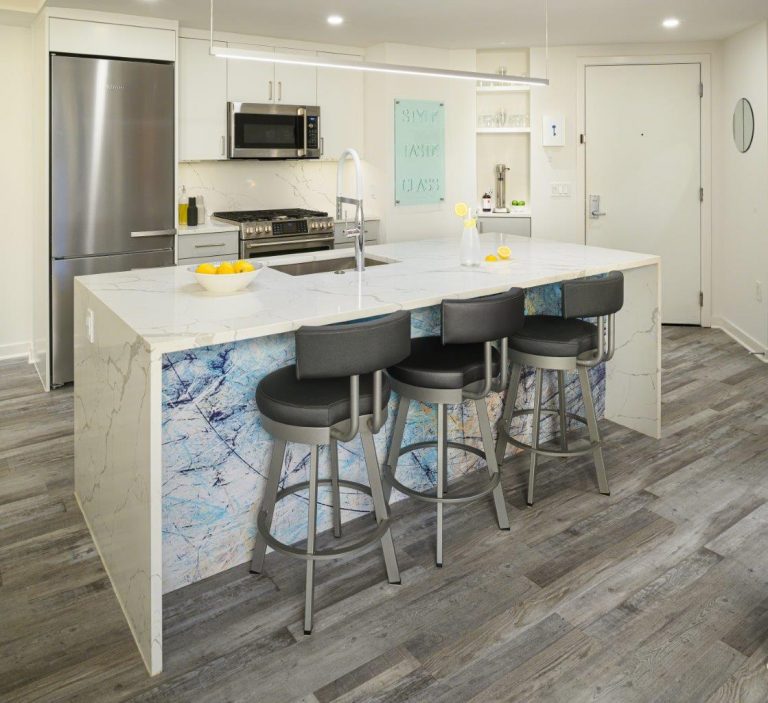 case design kitchen in DC has LED Linear Pendant packs a lot of lumens into an ultra-thin linear-suspension frame, minimal lines, maximum light and a marble kitchen island with three seatings