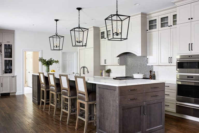 transitional kitchen in maryland home white outer cabinets gray toned brown island with seating and pendant lighting