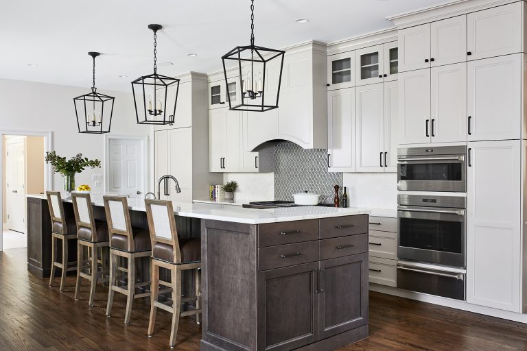 transitional kitchen in maryland home white outer cabinets gray toned brown island with seating and pendant lighting