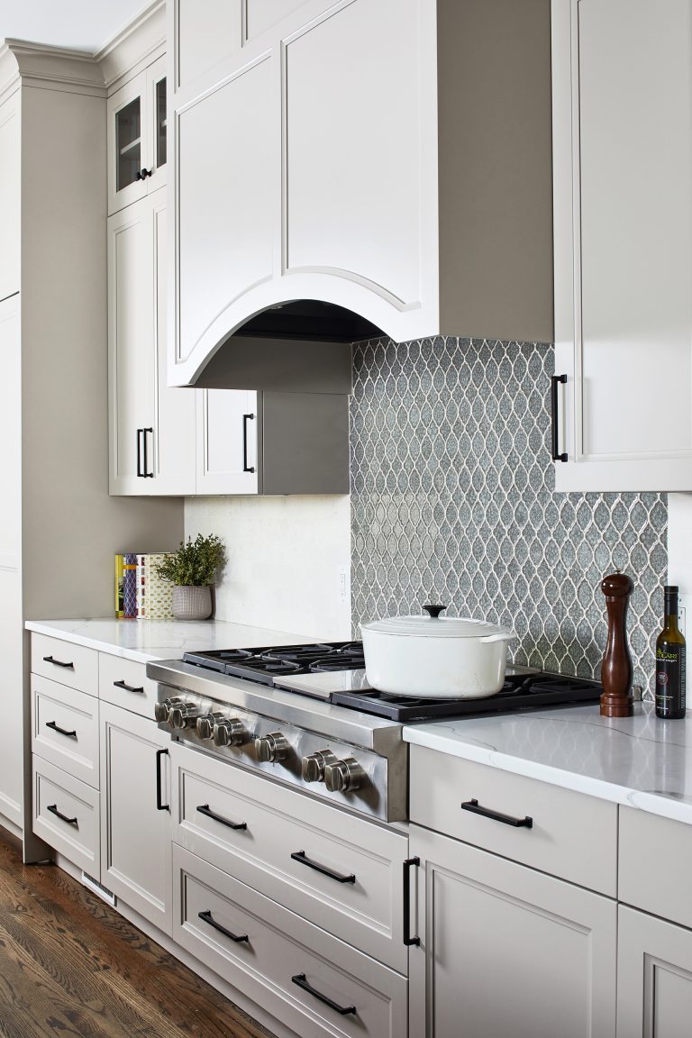 stainless steel gas stovetop range with wood paneled arched hood