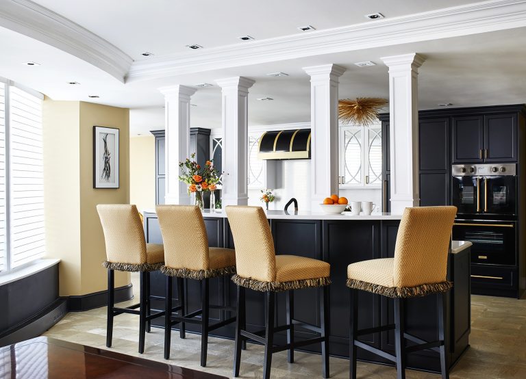 large traditional galley dark wood floor enclosed kitchen with a farmhouse sink, marble countertops, white backsplash